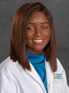 Headshot of Margaret Uchefuna wearing a white physicians coat over a teal turtle neck.